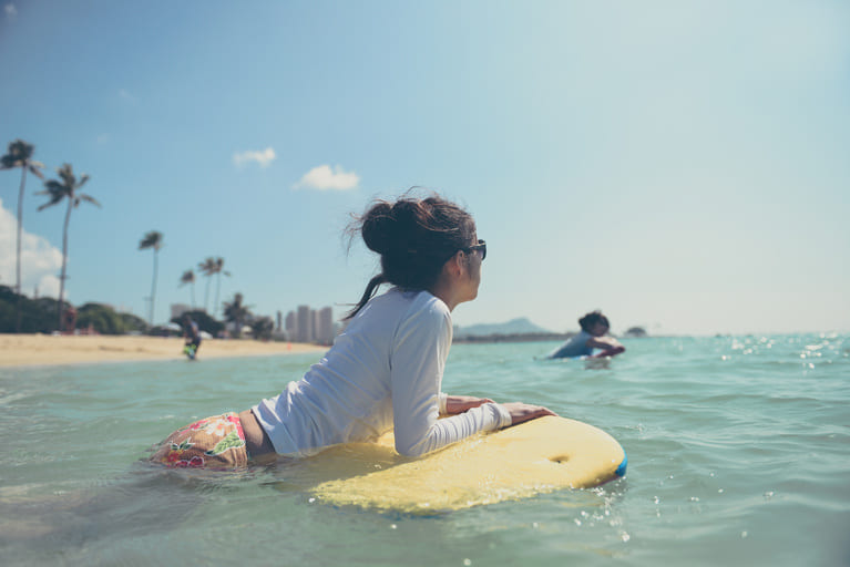 woman surfing in hawaii